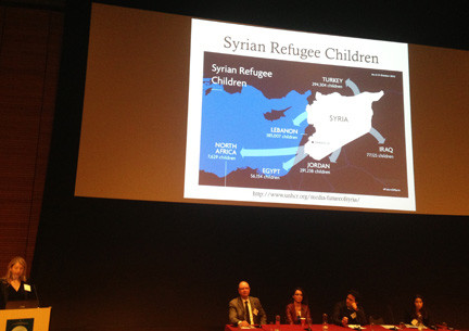 Sarah Tobin, left, presents an overview of the Syrian refugee crisis.