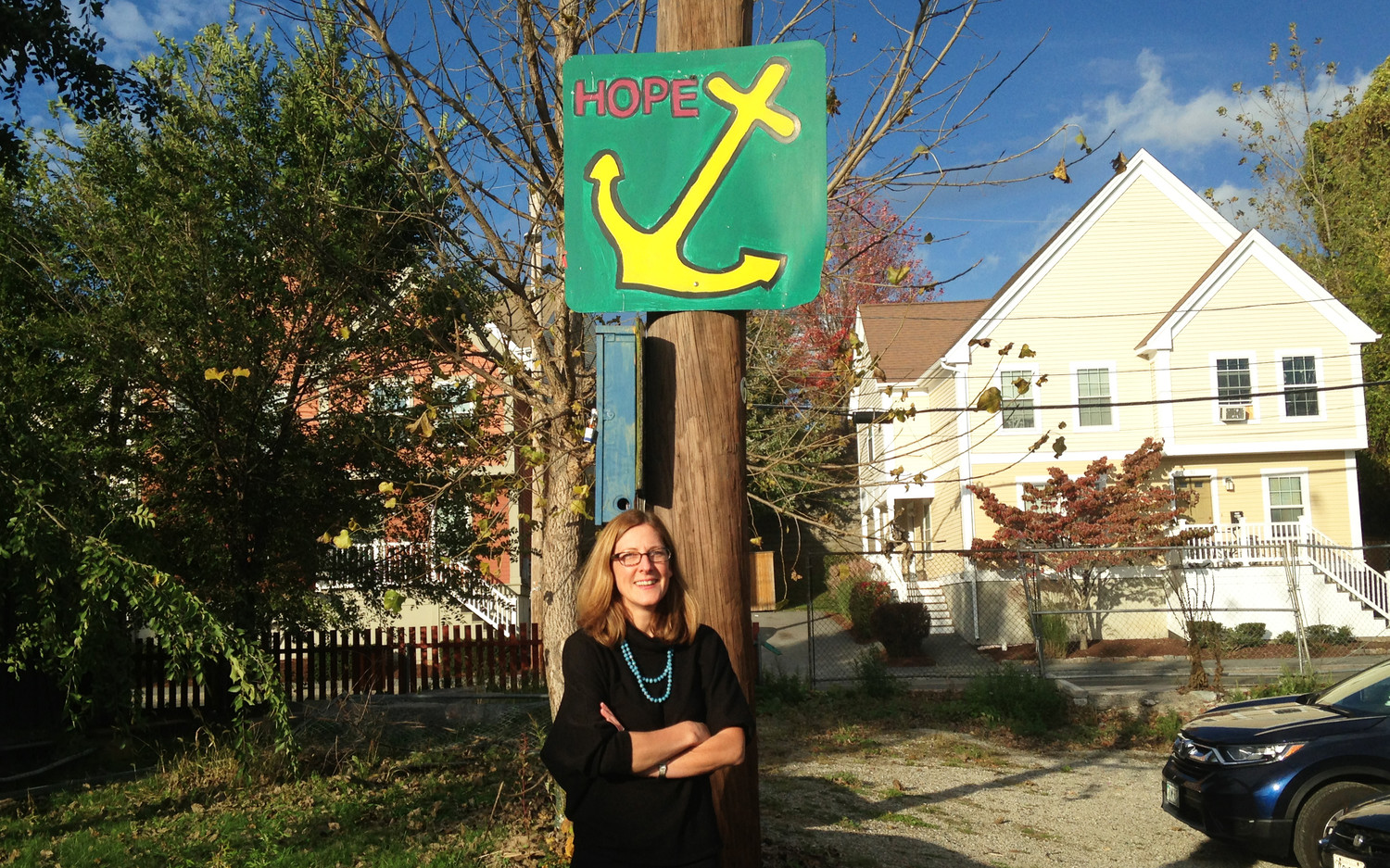 Jennifer Hawkins, executive director of the ONE Neighborhood Builders community development corporation, standing in Riverside Park, with some of the new homes her group has developed in Olneyville behind her, during a trolley tour organized by Rhode Island Housing.