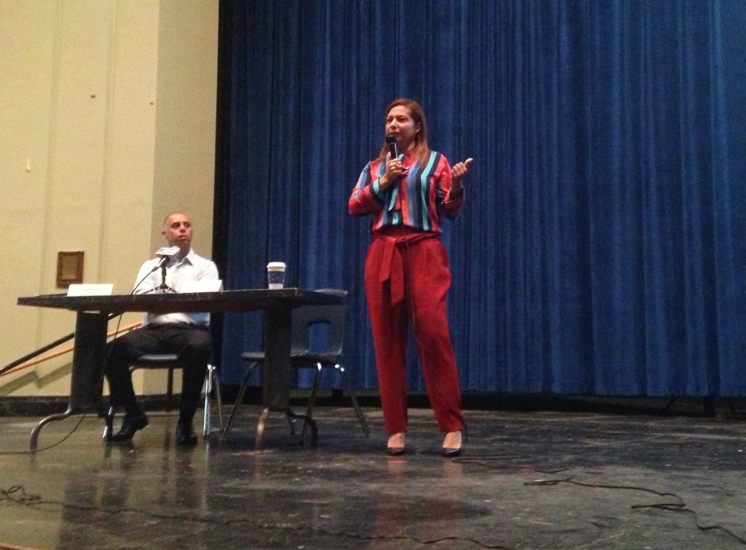 Angelica Infante-Green, right, commissioner of Rhode Island schools, opens a listening session at Hope High School with an extended monologue, Providence Mayor Jorge Elorza, left, spoke first.
