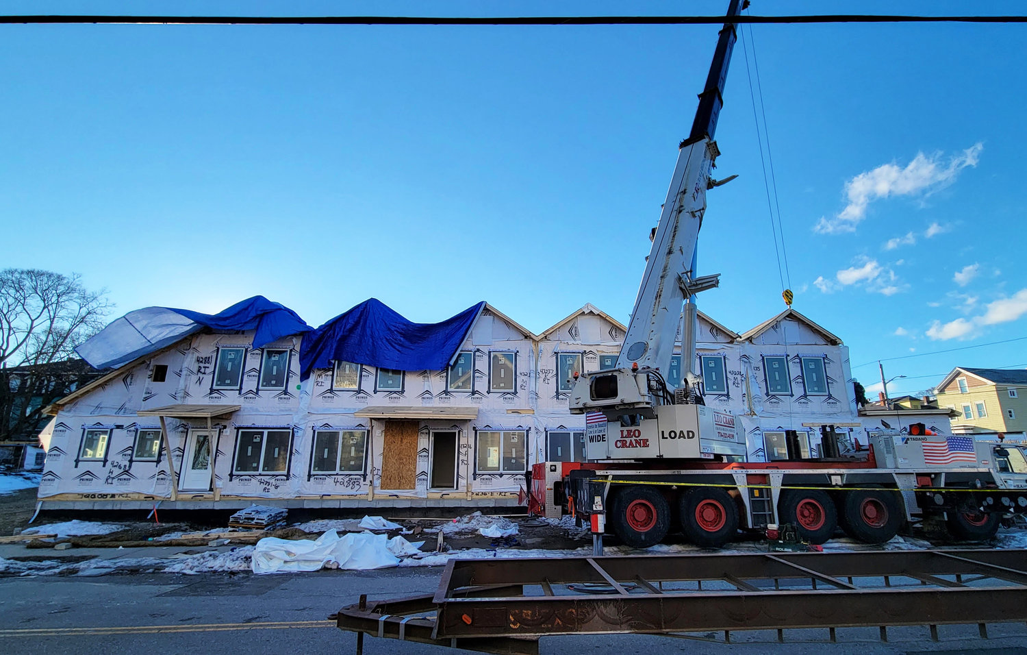 A crane lowers a modular unit into place at the Bowdoin Street site. The eight modular units of affordable housing are expected to be ready for occupancy in May.