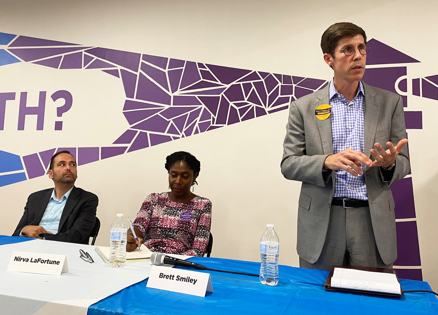 Brett Smiley, right, answers a question at the Aug. 4 Mayoral Forum at the Jim Gillen Teen Center, as candidates Gonzalo Cuervo, left, and Nirva LaFortune, center, listen.